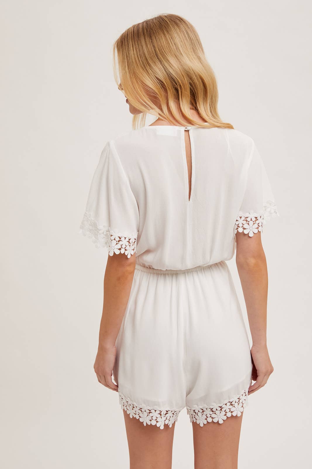WRAP FLORAL LACE TRIMMED DRAWSTRING ROMPER: ALMOND