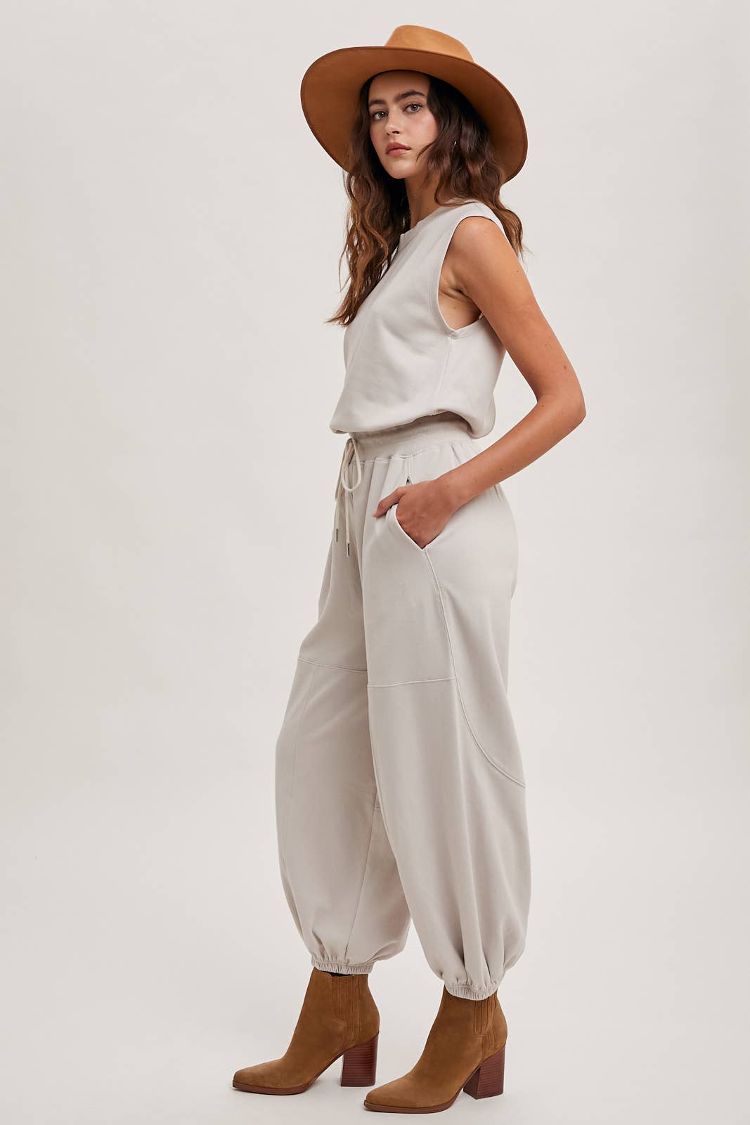 DRAWSTRING WAIST SLEEVELESS KNIT ACIVE JUMPSUIT: ECRU