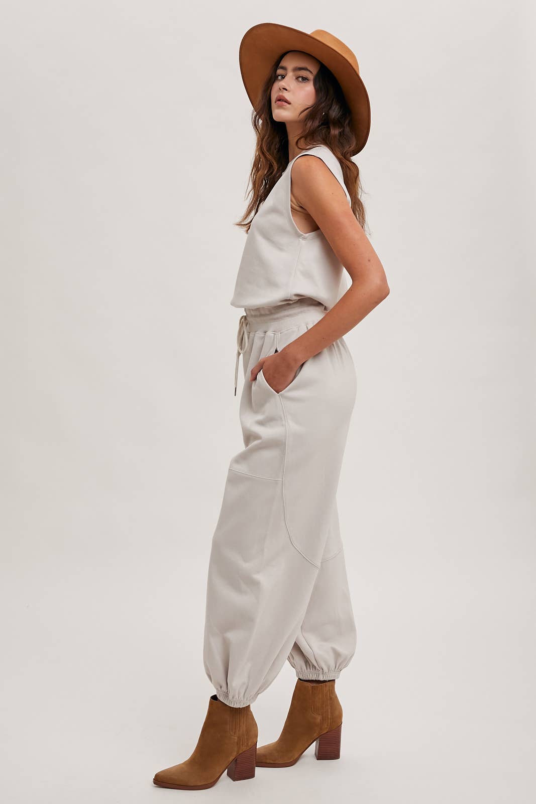 DRAWSTRING WAIST SLEEVELESS KNIT ACIVE JUMPSUIT: ECRU