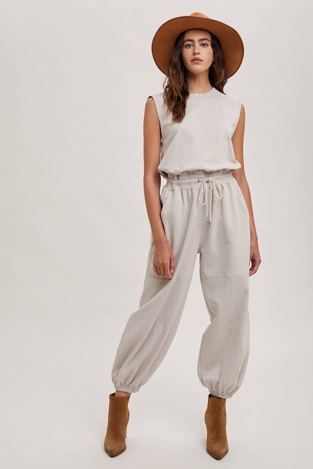 DRAWSTRING WAIST SLEEVELESS KNIT ACIVE JUMPSUIT: ECRU